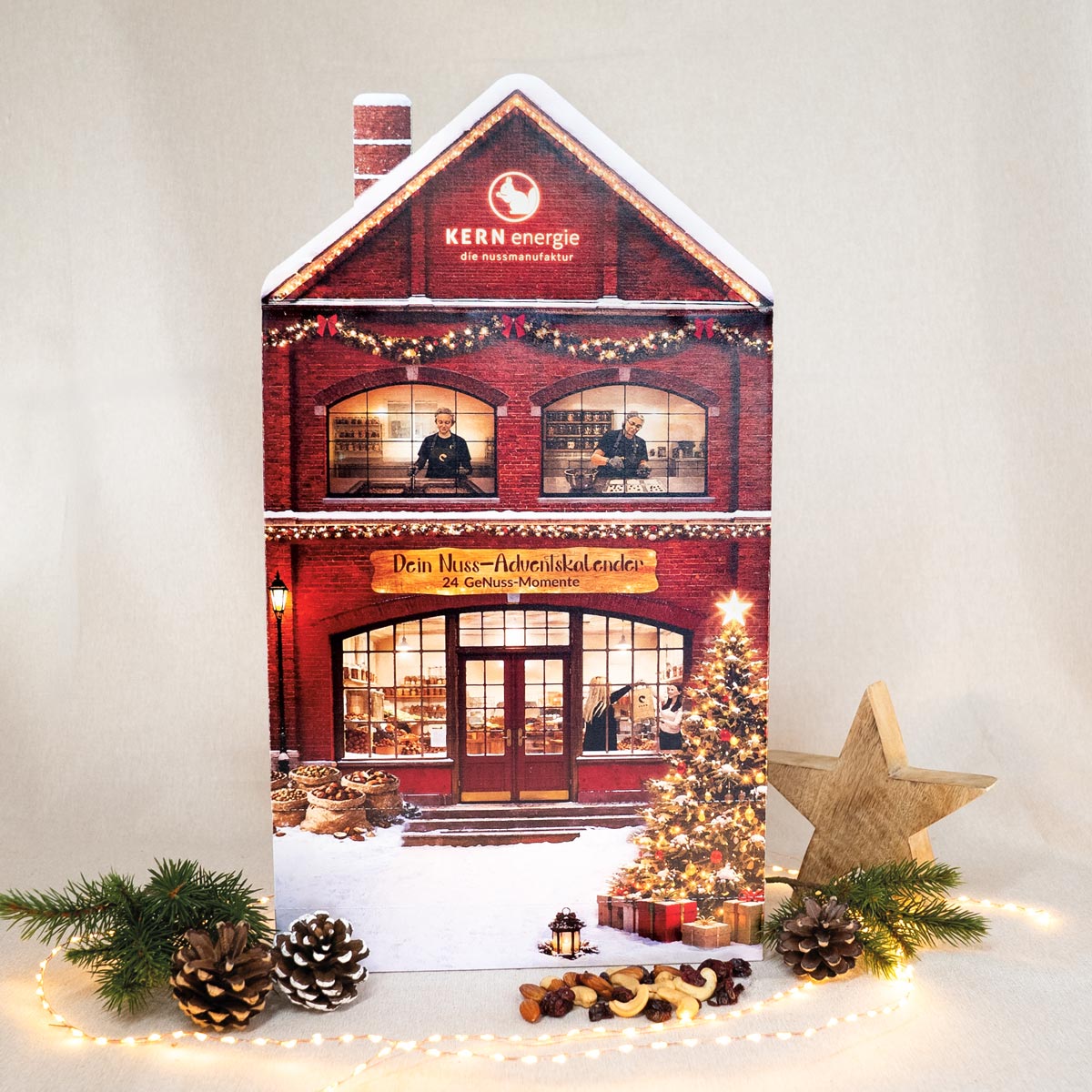Manufaktur Adventskalender in Form eines Hauses mit Nüssen und weihnachtlicher Deko